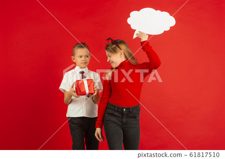 Valentine's day celebration, happy caucasian kids isolated on red background 61817510