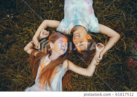 Two cute girls have fun in a summer park Two cute girls have fun in a summer park 61817512