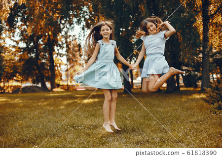 Two cute girls have fun in a summer park Two cute girls have fun in a summer park 61818390