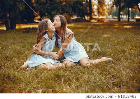 Two cute girls have fun in a summer park Two cute girls have fun in a summer park 61818462