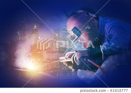 Welding worker welding steel structure with modern 61818777