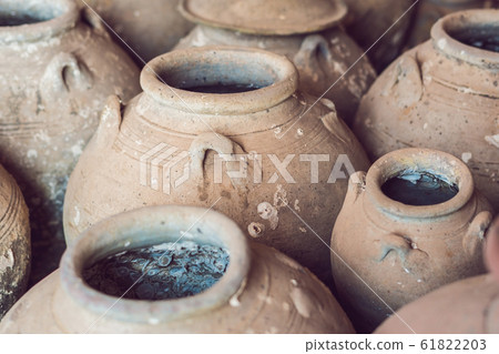 Ancient Vietnamese traditional pots overgrown with seashells Ancient Vietnamese traditional pots overgrown with seashells 61822203