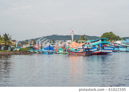 A group of colourful boats moored at Phu Quoc Vietnam. Boats such as these are iconic of the seaside port A group of colourful boats moored at Phu Quoc Vietnam. Boats such as these are iconic of the seaside port 61822595