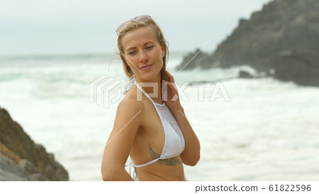 Sexy girl wearing a bikini at the beach - summer vacation at the ocean 61822596