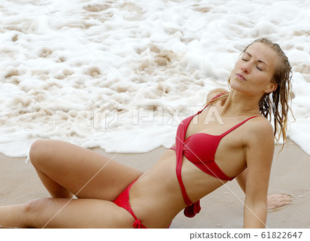 Sexy girl poses for the camera - happy girl on summer vacation at the beach Sexy girl poses for the camera - happy girl on summer vacation at the beach 61822647