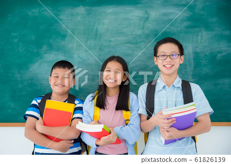 Three happy asian students holding book and smile Three happy asian students holding book and smile 61826139
