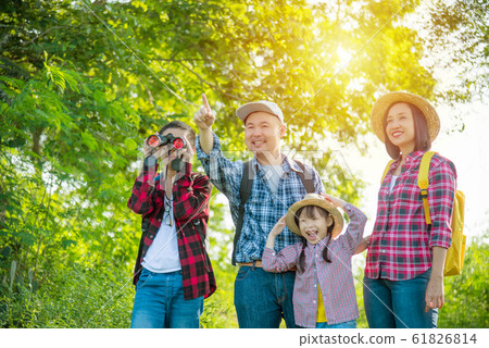 Happy asian family trekking in forest together on vacation 61826814