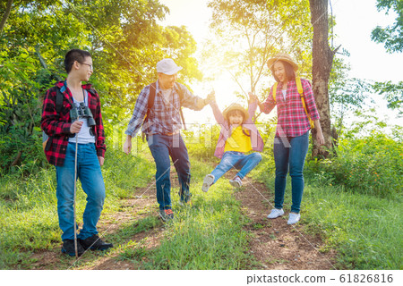 Happy asian family trekking in forest together on vacation Happy asian family trekking in forest together on vacation 61826816