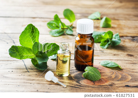 Essential aroma oil with peppermint on wooden 61827531