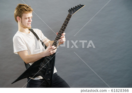 Man playing on electric guitar 61828366