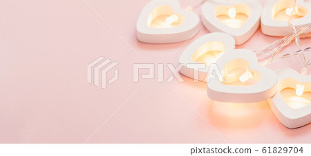 Delicate pink background with heart garland. Delicate pink background with heart garland. 61829704