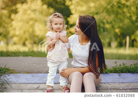 Mother with daughter playing in a summer park Mother with daughter playing in a summer park 61832088