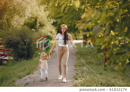 Mother with daughter playing in a summer park 61832274