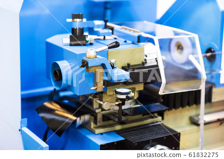 Metalworking CNC milling machine. Cutting metal modern processing technology. Small depth of field. Warning - authentic shooting in challenging conditions. A little bit grain and maybe blurred. 61832275