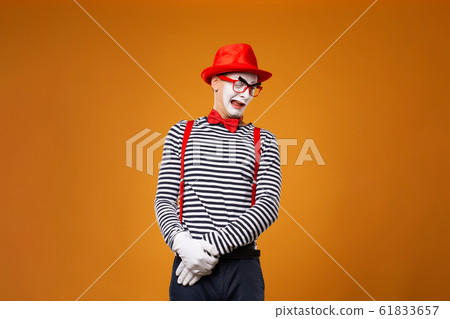 Sad mime man in vest and red hat Isolated 61833657