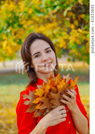 Beautiful happy woman with a bouquet of yellow 61833685
