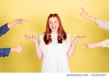 Caucasian young woman's portrait on yellow background, too much tasks Caucasian young woman's portrait on yellow background, too much tasks 61834297