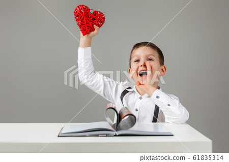 child boy with red heart and book child boy with red heart and book 61835314