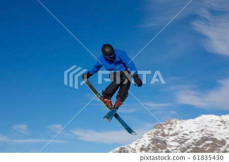 Freestyle ski jumper with crossed skis Freestyle ski jumper with crossed skis 61835430