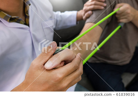 instructor assisting senior doing exercise working 61839016
