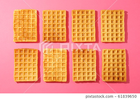 Flat lay composition with belgian waffles on color Flat lay composition with belgian waffles on color 61839650