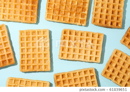 Flat lay composition with belgian waffles on color Flat lay composition with belgian waffles on color 61839651