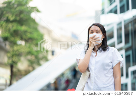 Woman wearing face mask protect filter against air Woman wearing face mask protect filter against air 61840597