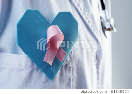 doctor with a blue heart and a pink ribbon 61840964