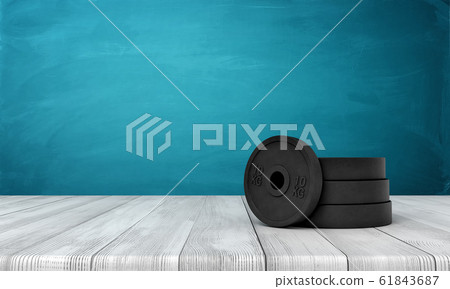 3d rendering of black weight plates on white wooden floor and dark turquoise background 3d rendering of black weight plates on white wooden floor and dark turquoise background 61843687