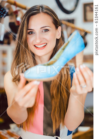 Woman shopping for shoes falls in love with blue high heels 61844161