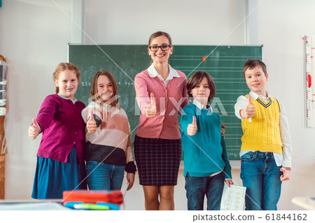 Thumbs up given by pupils and teacher because school is great Thumbs up given by pupils and teacher because school is great 61844162