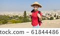 Girl is standing on hill and looking at Athens, 61844486