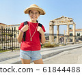 Happy girl is standing on street of Athens near 61844488
