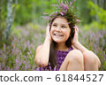 Happy girl is wearing heather wreath 61844527