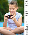 Girl is using smartphone 61844528