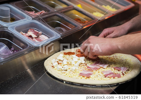 making pizza at kitchen of pizzeria making pizza at kitchen of pizzeria 61845319