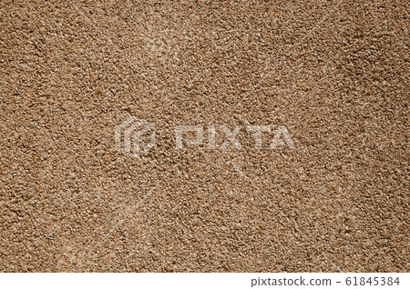 Close-up of wall with small gravel inserted into the plaster Close-up of wall with small gravel inserted into the plaster 61845384