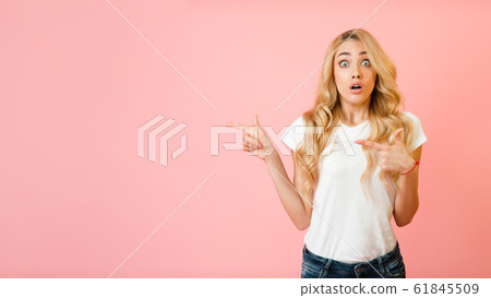 Omg, look! Shocked woman pointing at copy space Omg, look! Shocked woman pointing at copy space 61845509