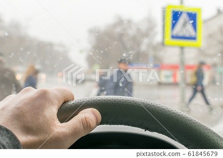 view from the car, a man's hand on the steering wheel of the car view from the car, a man's hand on the steering wheel of the car 61845679