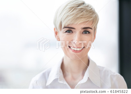 Portrait Of Successful Business Lady Posing Near Window In Office Portrait Of Successful Business Lady Posing Near Window In Office 61845822