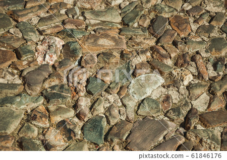 Close-up of street pavement made of rough stones in Caceres Close-up of street pavement made of rough stones in Caceres 61846176