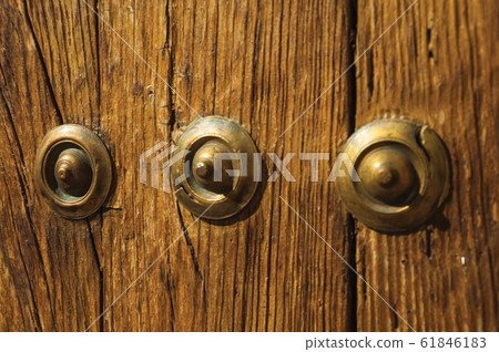 Bronze studs attached to wooden planks in Caceres 61846183
