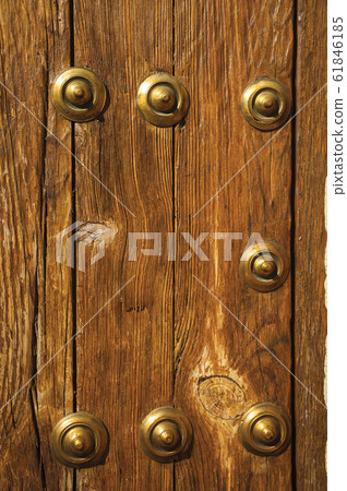 Bronze studs attached to wooden planks in Caceres 61846185