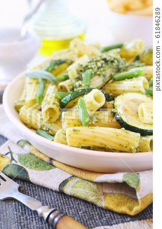 Italian penne pasta with roasted zucchini, pesto sauce and green beans 61846289