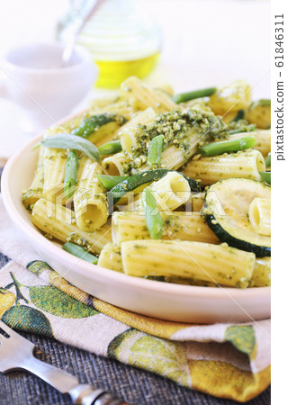 Italian penne pasta with roasted zucchini, pesto sauce and green beans 61846311