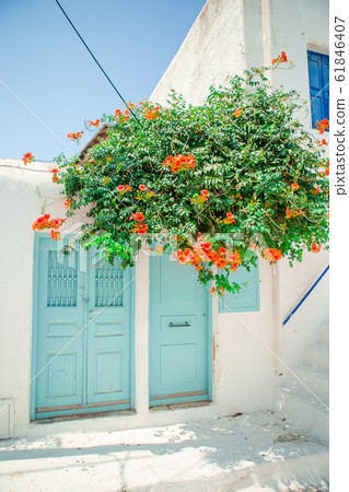 Traditional houses withe blue doors in the narrow streets of Mykonos, Greece. 61846407