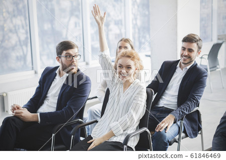 Confident businesswoman raising hand to ask question at seminar 61846469