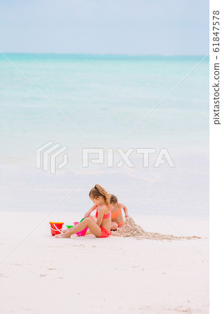 Adorable little girls during summer vacation on the beach 61847578