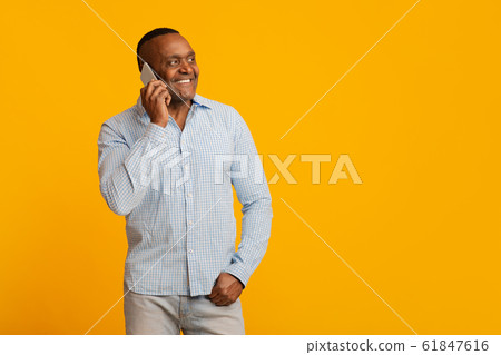 Positive mature afro man talking on cellphone Positive mature afro man talking on cellphone 61847616