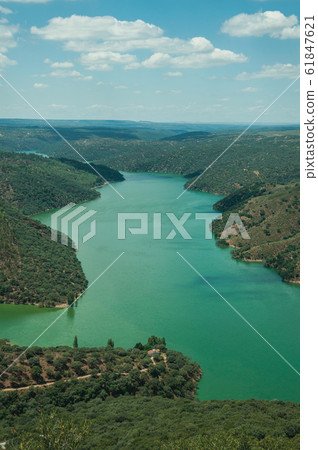 Tagus River running through a hilly valley at the Monfrague National Park Tagus River running through a hilly valley at the Monfrague National Park 61847621